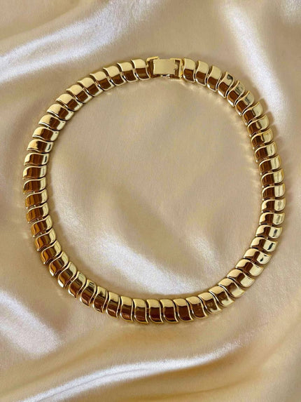 Collier dorato con moduli a onda