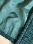 Cappotto doppiopetto in lana bouclé verde bosco con fodera firmata