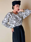 Blusa Yves Saint Laurent in tessuto jacquard bianco e nero fantasia Domino