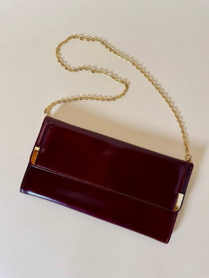 Pochette in pelle spazzolata bordeaux con tracolla in catena