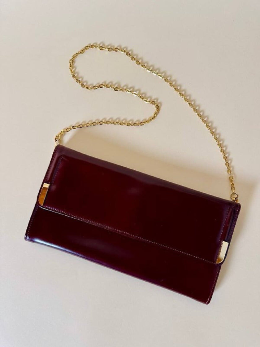 Pochette in pelle spazzolata bordeaux con tracolla in catena
