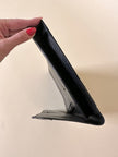Pochette vintage Yves Saint Laurent in pelle nera con greca logata in rilievo
