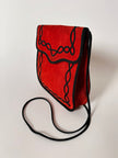 Borsa vintage Yves Saint Laurent in camoscio rosso con passamaneria nera