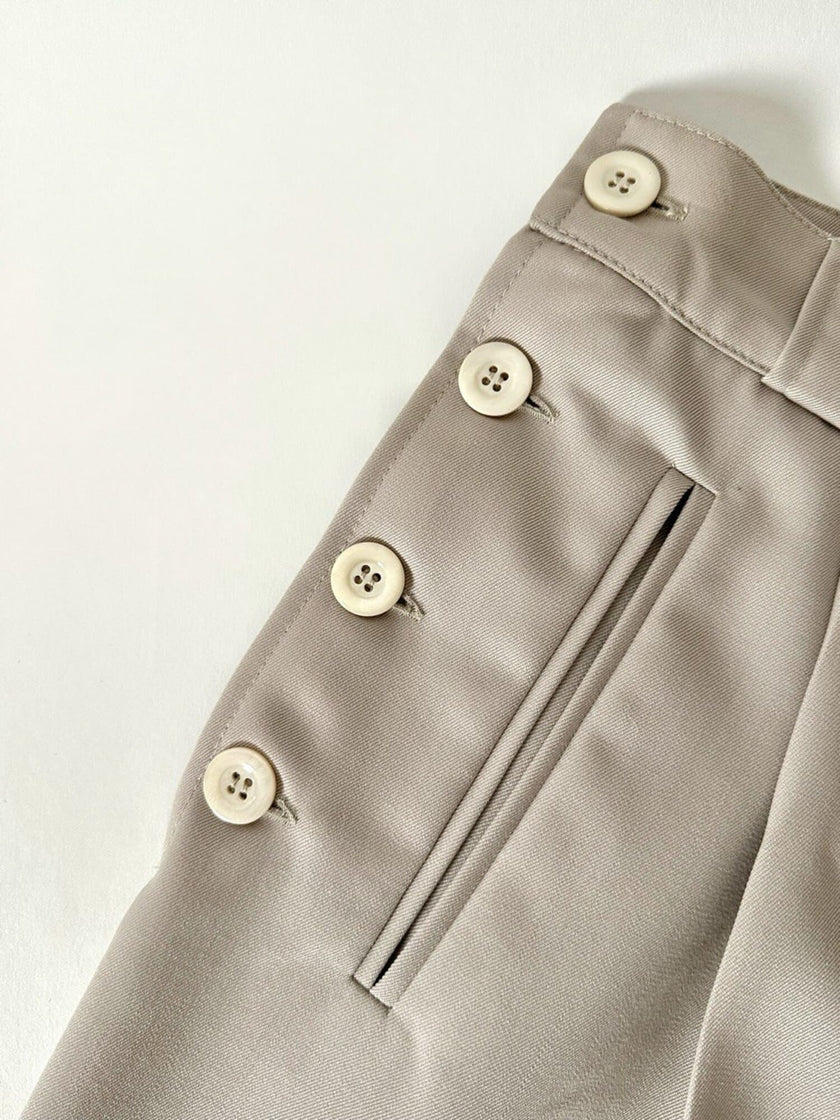 Pantalone vintage in fresco di lana greige con pince e abbottonatura su ambo i lati