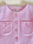 Blazer in lana bouclé rosa con bottoni gioiello logati in madreperla “Yves Saint Laurent”