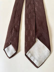 Cravatta Yves Saint Laurent in seta jacquard marrone con logo YSL allover