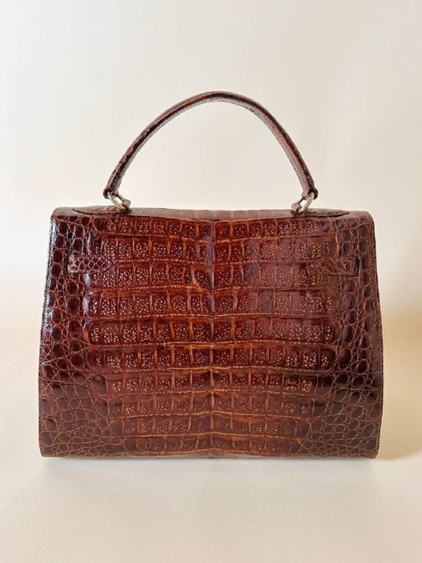 Borsa a trapezio in pelle di coccodrillo color cognac con tracolla e hardware oro Idra