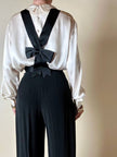 Pantalone nero con bretelle e maxi fiocchi in raso “Moschino Cheap and Chic”