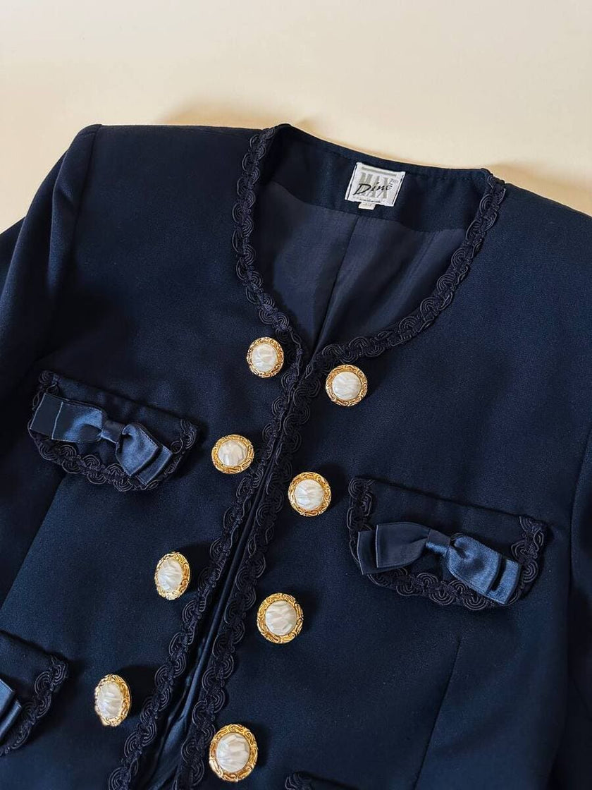 Bolero blu con bottoni gioiello e fiocchi “Max Dinè”