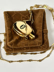 Collana vintage Gucci dorata con piccola bottiglia porta profumo