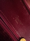 Sac à dos Must de Cartier en cuir bordeaux avec finitions dorées