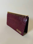 Pochette a quaderno in pelle bordeaux stampa coccodrillo “Moschino”