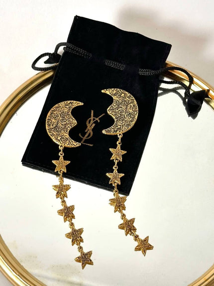 Orecchini vintage Yves Saint Laurent con lune e stelle pendenti dorate