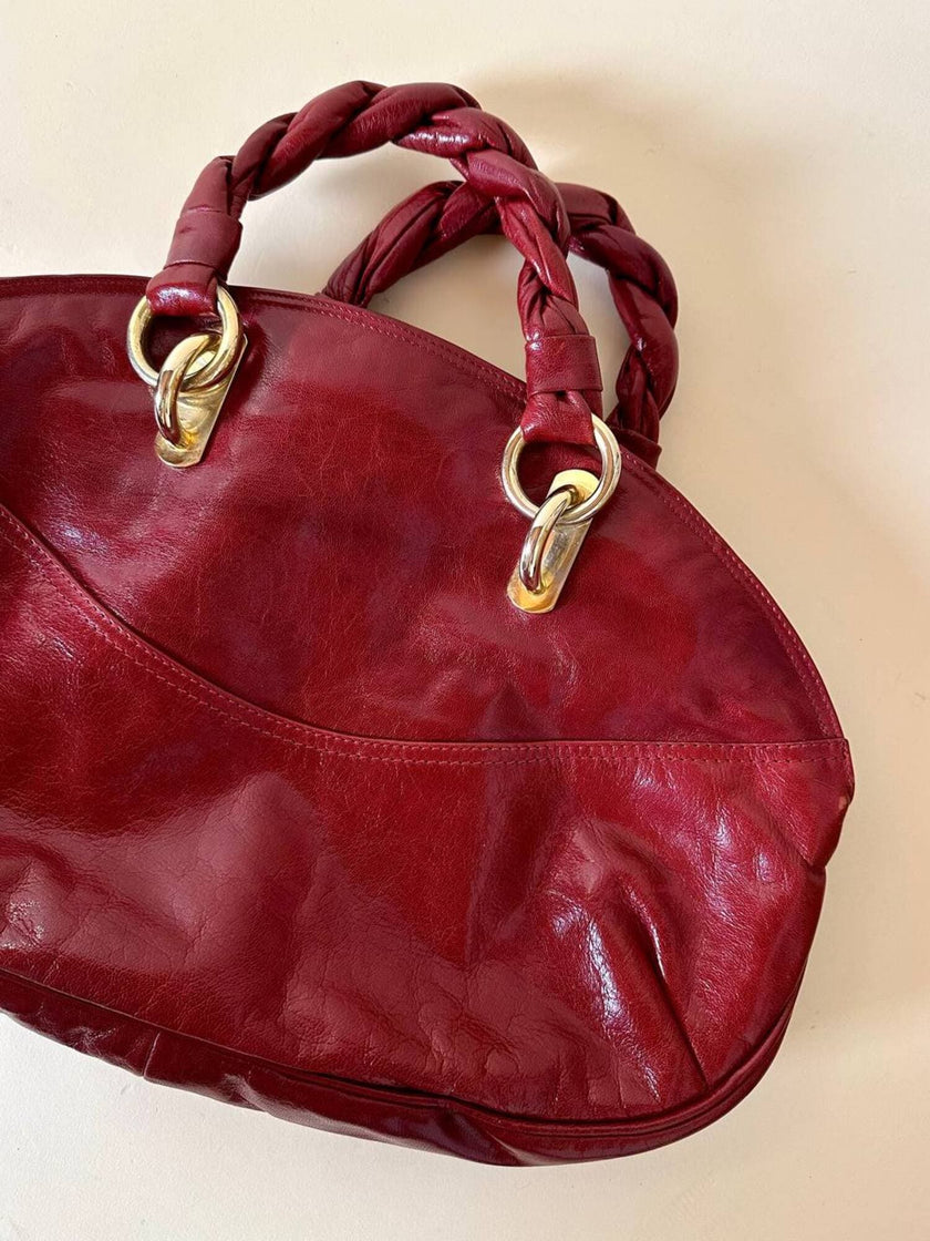 Borsa in pelle rosso bruciato con manici a treccia