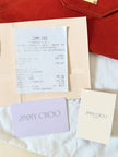 Pochette a busta Jimmy Choo in camoscio aragosta con placca metallica logata