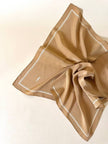 Foulard in seta beige con profili e logo bianchi “Yves Saint Laurent”