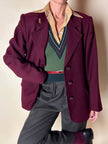 Gilet in lana verde prato con scollo a V e profili a contrasto verde bosco