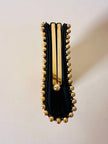 Clutch gioiello in seta nera con armatura di perline dorate “Rodo”