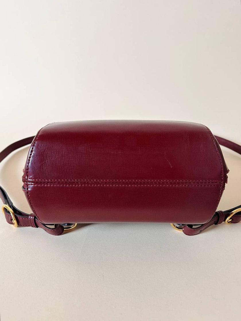Sac à dos Must de Cartier en cuir bordeaux avec finitions dorées