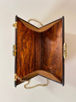 Bolso rígido Marie Antoinette de lucita con efecto carey y correa de cadena dorada