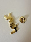 Spilla logo YSL dorata con dust nera “Yves Saint Laurent”