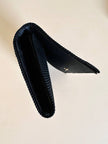 Pochette nera con fiocco in tessuto canneté