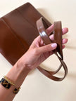Borsa Yves Saint Laurent in pelle spazzolata color cuoio con accessorio gioiello