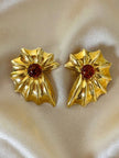 Orecchini a clip dorati a forma di conchiglia con cabochon centrale in ambra sintetica