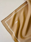 Foulard in seta beige con profili e logo bianchi “Yves Saint Laurent”