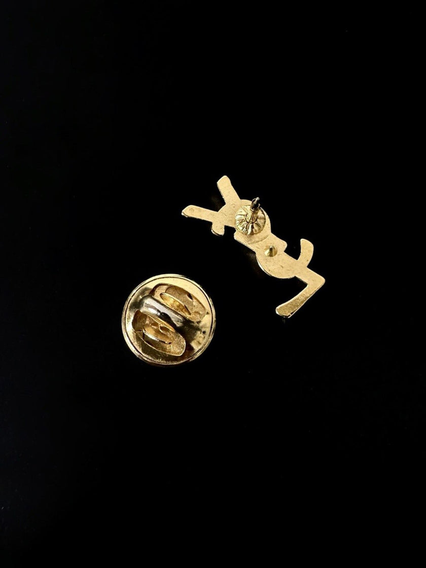 Mini spilla vintage logo Yves Saint Laurent in metallo dorato