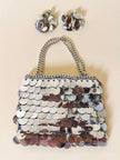 Parure composta da clip e mini bag in paillettes argento