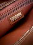 Borsa Yves Saint Laurent in pelle spazzolata color cuoio con accessorio gioiello