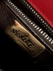 Borsa rossa in coccodrillo con borchie argento e tracolla metallica “Nicolette”