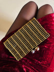 Clutch gioiello in seta nera con armatura di perline dorate “Rodo”