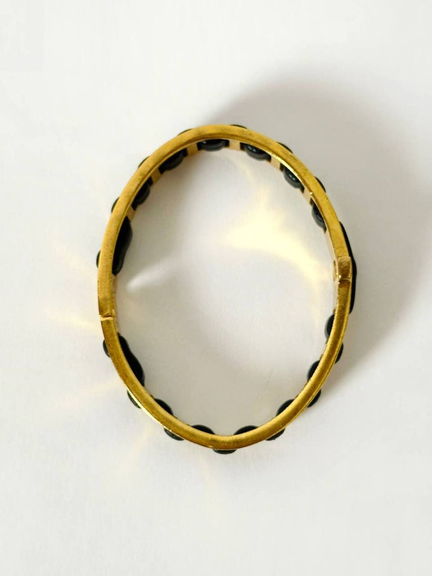 Bracciale vintage Fendi in metallo dorato con inserti in pelle nera intrecciata