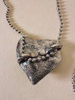 Collier argento con ciondolo a forma di cuore e cristalli incastonati “Yves Saint Laurent”