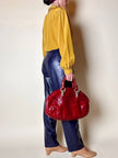 Borsa in pelle rosso bruciato con manici a treccia
