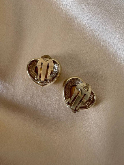 Clip dorate a forma di cuore con strass centrale