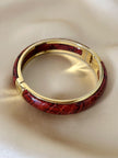 Bracciale vintage rigido in metallo dorato e pelle di serpente rossa