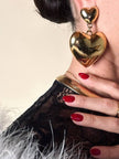 Maxi clip oro con cuori pendenti “Moschino”