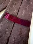 Cravatta Yves Saint Laurent in seta jacquard marrone con logo YSL allover