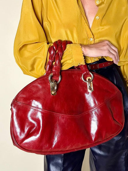 Borsa in pelle rosso bruciato con manici a treccia