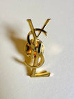 Spilla logo YSL dorata con dust nera “Yves Saint Laurent”