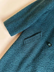 Cappotto doppiopetto in lana bouclé verde bosco con fodera firmata