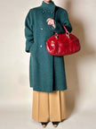 Cappotto doppiopetto in lana bouclé verde bosco con fodera firmata