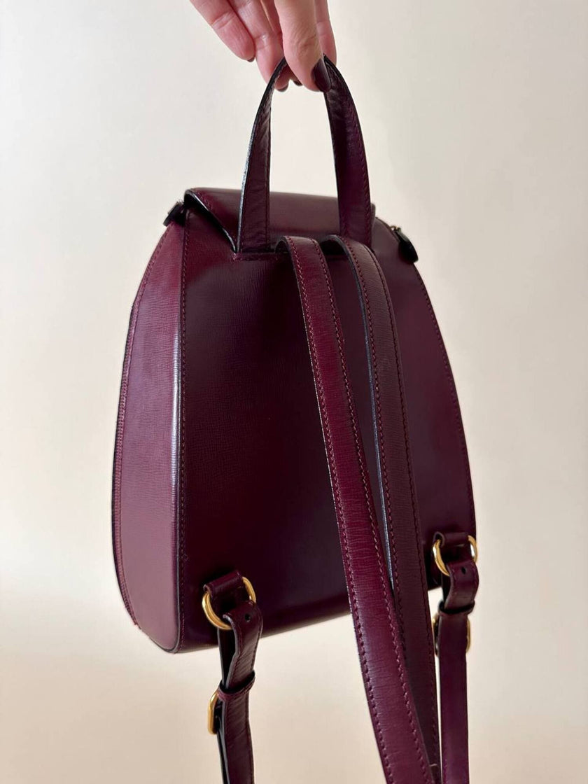 Sac à dos Must de Cartier en cuir bordeaux avec finitions dorées