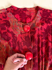 Jumpsuit sartoriale a fantasia floreale nei toni del rosso e maxi bottoni