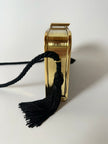 Borsa vintage in velluto nero con struttura dorata e nappe laterali