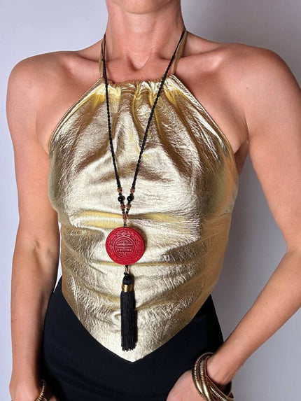 Top vintage con schiena nuda in pelle laminata oro