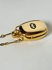 Collana vintage Gucci dorata con piccola bottiglia porta profumo